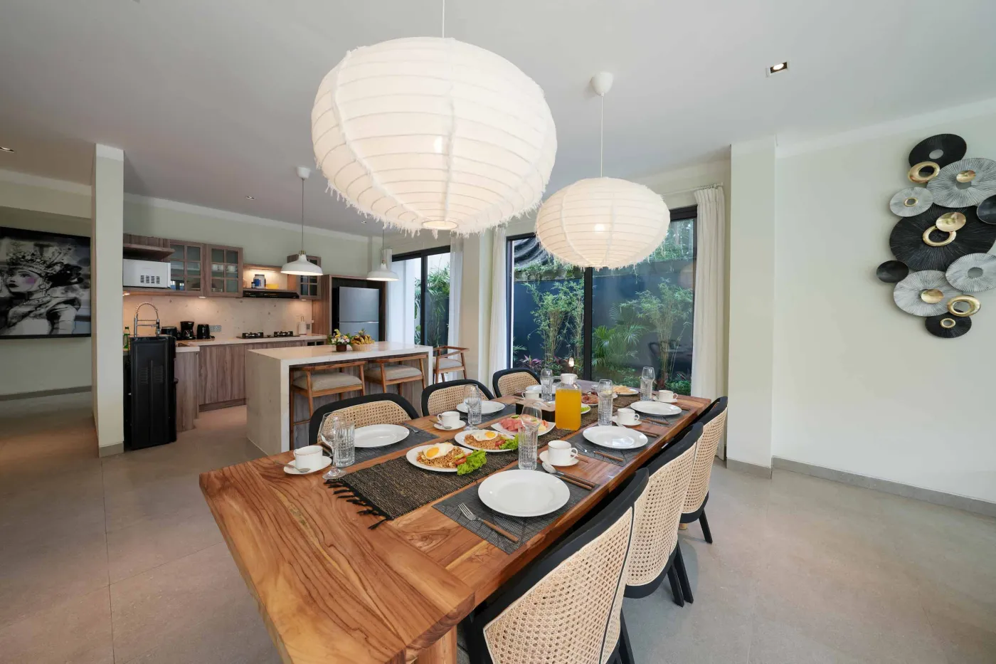 White freestanding bathtub filled with water and floating red rose petals in a modern spa-like bathroom. - Bali Villas