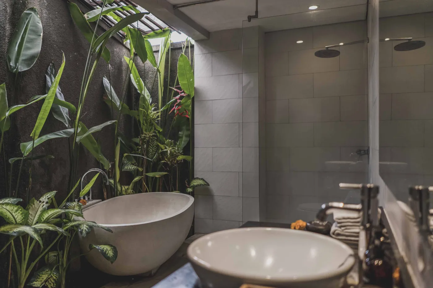 Luxury Bali villa bedroom with king bed, private infinity pool beyond sliding doors, wooden accents, and Netflix on TV. - Bali Villas