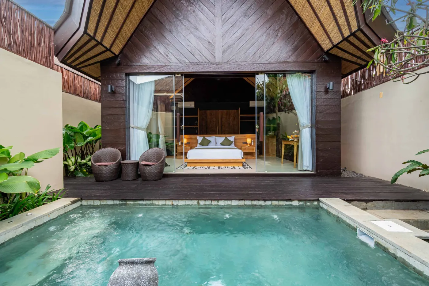 Luxury Balinese villa with private infinity pool, wooden deck, and open bedroom overlooking tropical gardens. - Bali Villas
