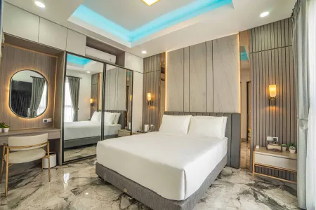 Modern luxury bedroom interior with king-size bed, vanity desk, mirrored wardrobes, and blue LED accent lighting.