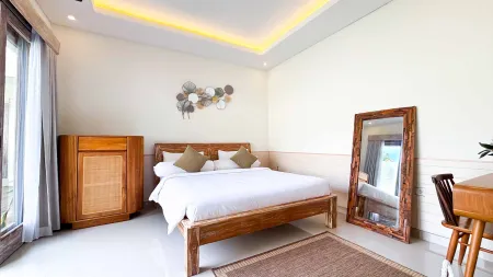 Cozy tropical bedroom with wooden bed, rattan dresser, full-length mirror, desk, and shell wall art.