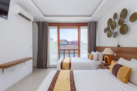 Spacious Balinese hotel bedroom with twin beds, wooden headboards, sliding doors to pool view, and tropical leaf wall art.