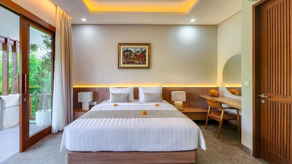 Serene Bali villa bedroom with king bed, tropical balcony view, wooden accents, and warm lighting.