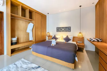 Luxurious Bali villa bedroom with king bed in purple linens, wooden wardrobe, pendant lamps, and frangipani accents.